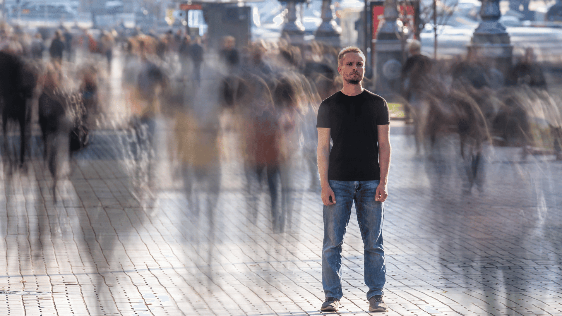Person standing still amidst a busy crowd, symbolizing the focus needed to manage OCD symptoms